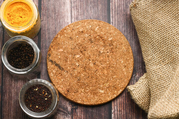 Spices for cooking and wooden table as background.
