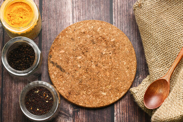 Spices for cooking and wooden table as background.