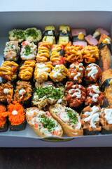 Various kinds of sushi served  on a white background.