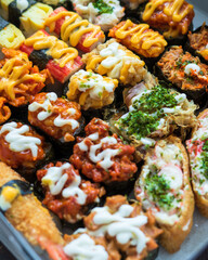 Various kinds of sushi served  on a white background.