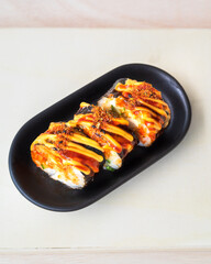 Korean food, gimbap or kimbap in a plate on a wooden background.