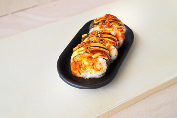 Korean food, gimbap or kimbap in a plate on a wooden background.