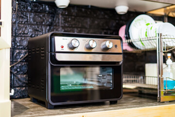 Air Fryer oven in the kitchen. Black Modern Electric Deep. Domestic Household & Small Kitchen Appliances.