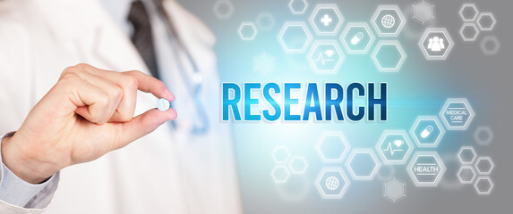 Close-up of a doctor giving you a pill with RESEARCH inscription, medical concept
