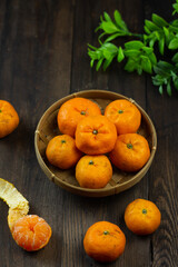 Jeruk Santang or Mandarin orange on wooden dark background. 
