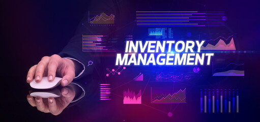 hand holding wireless peripheral with INVENTORY MANAGEMENT inscription, cyber business concept