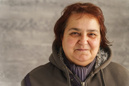 Close Up Portrait Of Mature Senior Caucasian Woman Looking To Camera - Female With Smile Real People Concept Copy Space Chubby With Red Hair