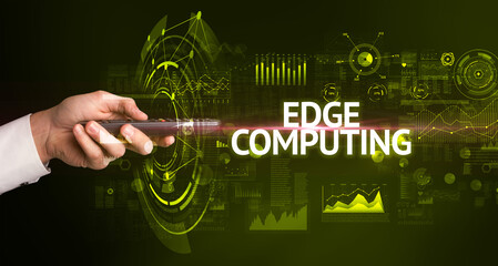 hand holding wireless peripheral with EDGE COMPUTING inscription, modern technology concept