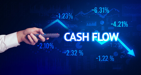 male hand holding wireless peripheral with CASH FLOW inscription, modern business concept