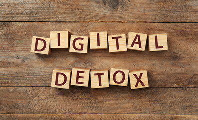 Cubes with words DIGITAL DETOX on wooden background, flat lay