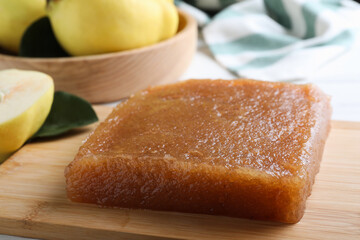 Delicious quince paste on wooden board, closeup