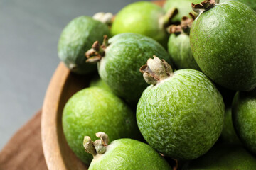 Plate with delicious fresh feijoas in bowl, closeup