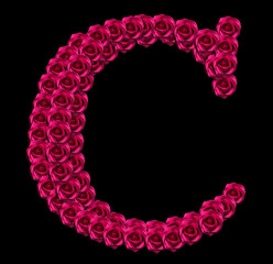 romantic concept image of a capital letter C made of red roses. Isolated on black background. Design element for love or valentines themes