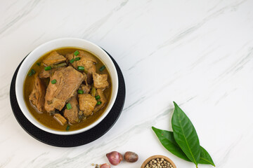 Semur Ayam Tahu, Indonesian traditional food made with chicken, tofu, spices, soy sauce and palm sugar. Marble background, copy space for text. 