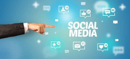 Close-Up of cropped hand pointing at SOCIAL MEDIA inscription, social networking concept