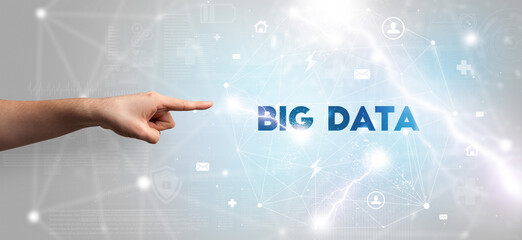 Hand pointing at BIG DATA inscription, modern technology concept