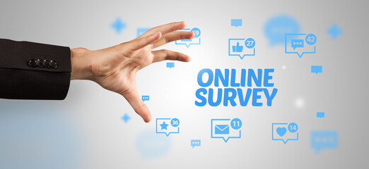 Close-Up of cropped hand pointing at ONLINE SURVEY inscription, social networking concept