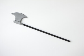 Plastic miniature model of pick axe with black handle. Toy ax isolated white background. 