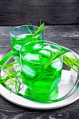 Lemonade Tarragon with ice in two glasses on black board