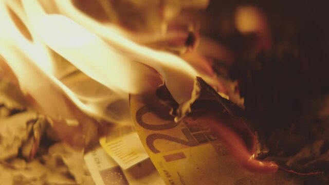 Two Hundred 200 Euros Banknote burning in a flame. Stock market crush concept.