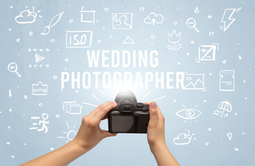 Hand taking picture with digital camera and WEDDING PHOTOGRAPHER inscription, camera settings concept