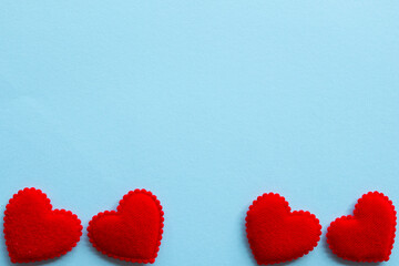 Love for valentines day,Red heart row border on light blue pastel paper background with copyspace.
