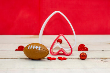 Football for Valentine's Day with red heart on red background