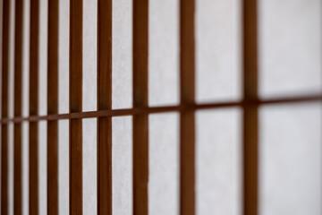 Close-up on a texture of a Washi paper used as Japanese shōji screen on a Kōshi wooden lattice...