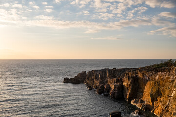 Rocky cliff formations during sunset at Sandanbeki Cliff in Shirahama, Wakayama Prefecture, Japan.