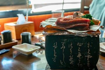 Raw meat cut into thin slices and grilled over charcoal, Japanese food
