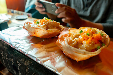 BangkokThailand - January 31 2021 : Kani miso, delicious crab paste grilled on a charcoal stove