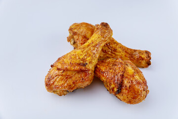 Grilled chicken drumsticks marinated with buffalo sauce isolated on white background.