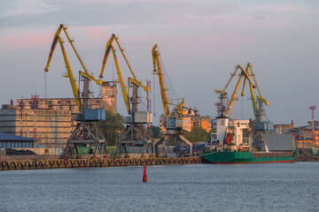 View of cargo port cranes October evening. Vyborg, Russia