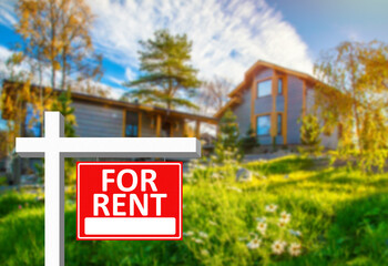 For rent sign next to a large house. For rent sign as a symbol of private property renting. for rent sign on a red background. Concept - rental a private  house. Renting a country house.