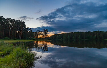 Fototapeta na wymiar Sunset over the pond in summer