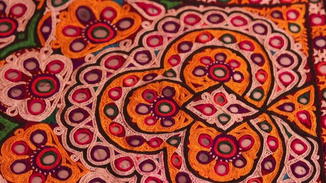 Mirrored embroidery work typical of the Aahir tribe,unidentified man embroidering cloth in traditional method of India,mirror work colorful handmade ahir bharat,Kutch-gujarat
