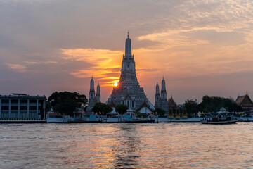Wat Arun Ratchawararam Ratchawaramahawihan or  Wat Arun meaning Temple of Dawn on Chao Phraya River at sunset , Bangkok , Thailand