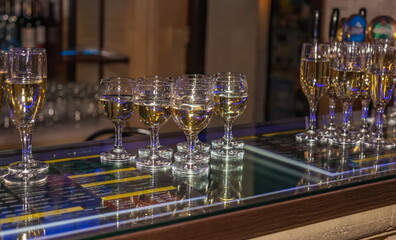 Glass glasses with champagne close up on the bar in a cafe