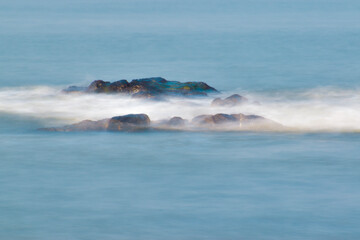 Splashes of waves on coastal rocks. Boulders beach splashes of waves