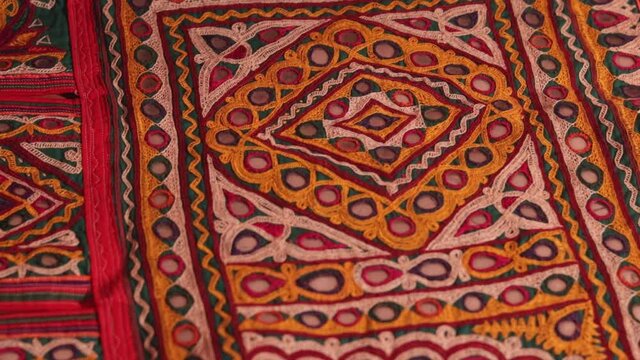 handwork embroidery,Handmade embroidery art. Traditional Indian handmade embroidery art,selective focus,mirror work colorful handmade ahir bharat,Kutch-gujarat