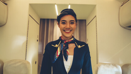 Cabin crew or air hostess working in airplane . Airline transportation and tourism concept.