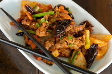 Szechuan beef on white plate