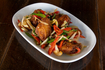 Chili chicken wings on a white plate