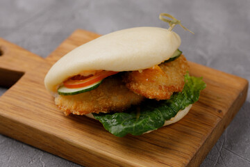 Bao buns. Hawaiian dish, on a wooden table. Pan-Asian cuisine concept. Close-up
