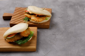 Bao buns. Hawaiian dish, on a wooden table. Pan-Asian cuisine concept. Close-up