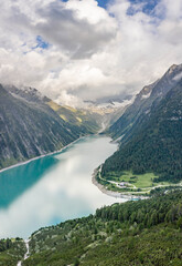 Aerial drone shot of Schlegeisspeicher resevoir with galcier view at dusk