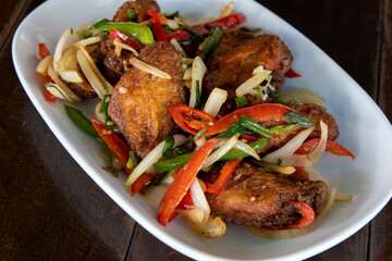 Chili chicken wings on a white plate
