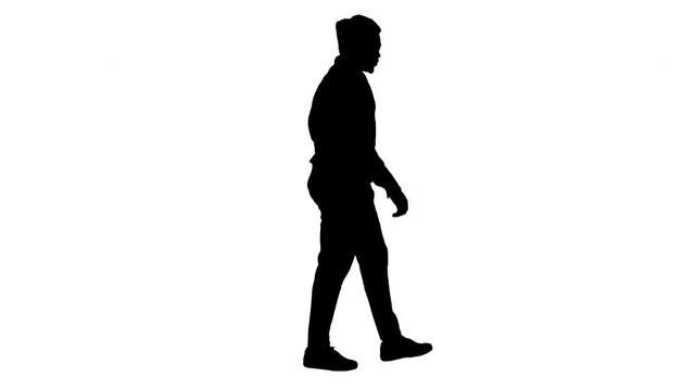 Silhouette Young african american man listening to music in headphones while walking.