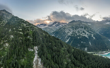 Aerial drone shot of Schlegeisspeicher resevoir with galcier view at dusk