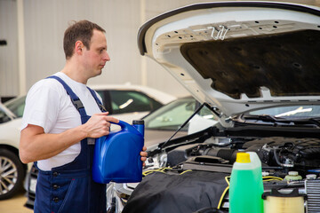Changing the oil in the car in the technical center.